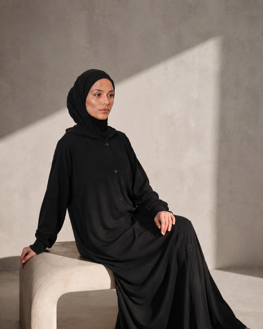 Full length view of the black hooded modest jacket
