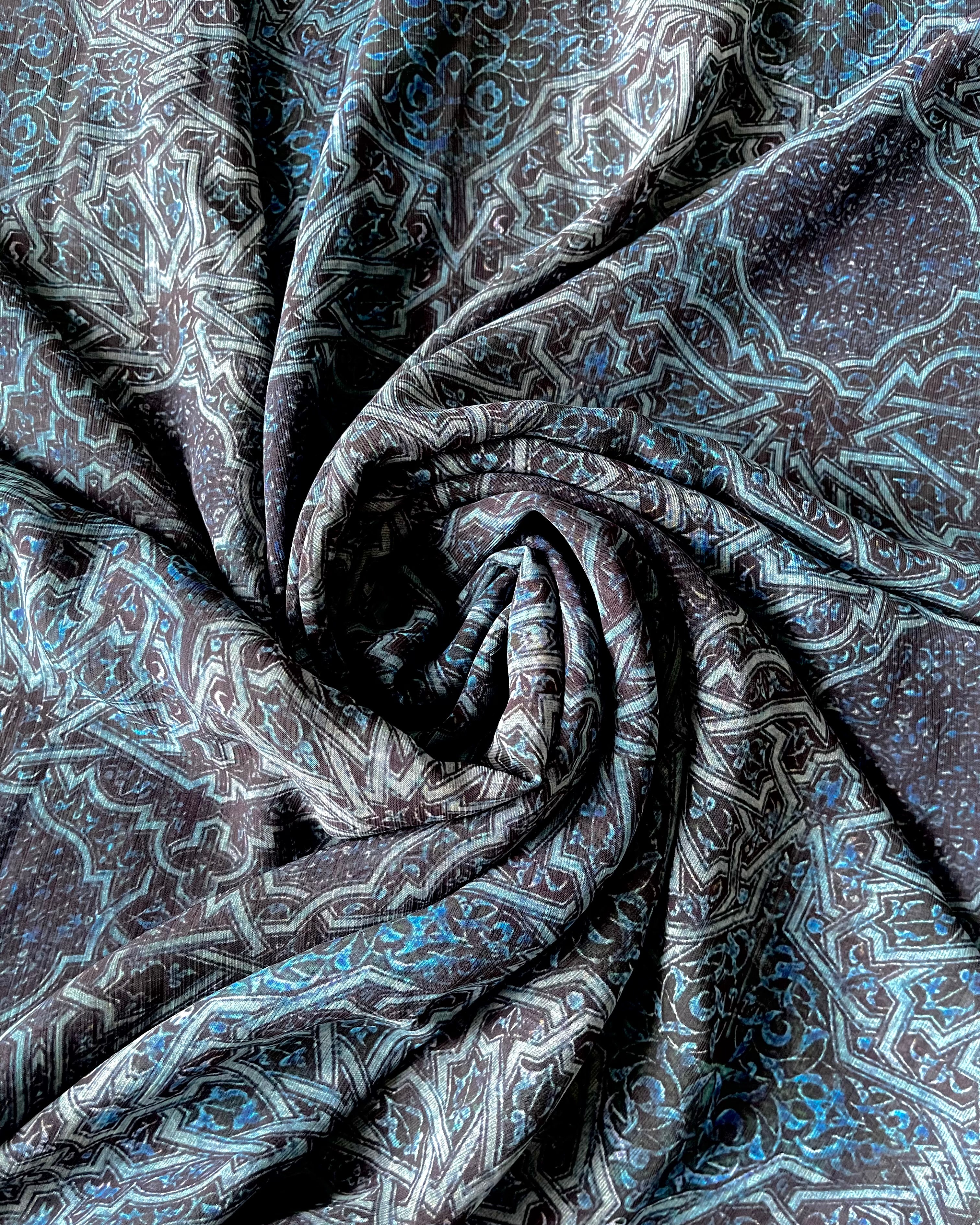 A royal blue chiffon hijab with intricate print details.