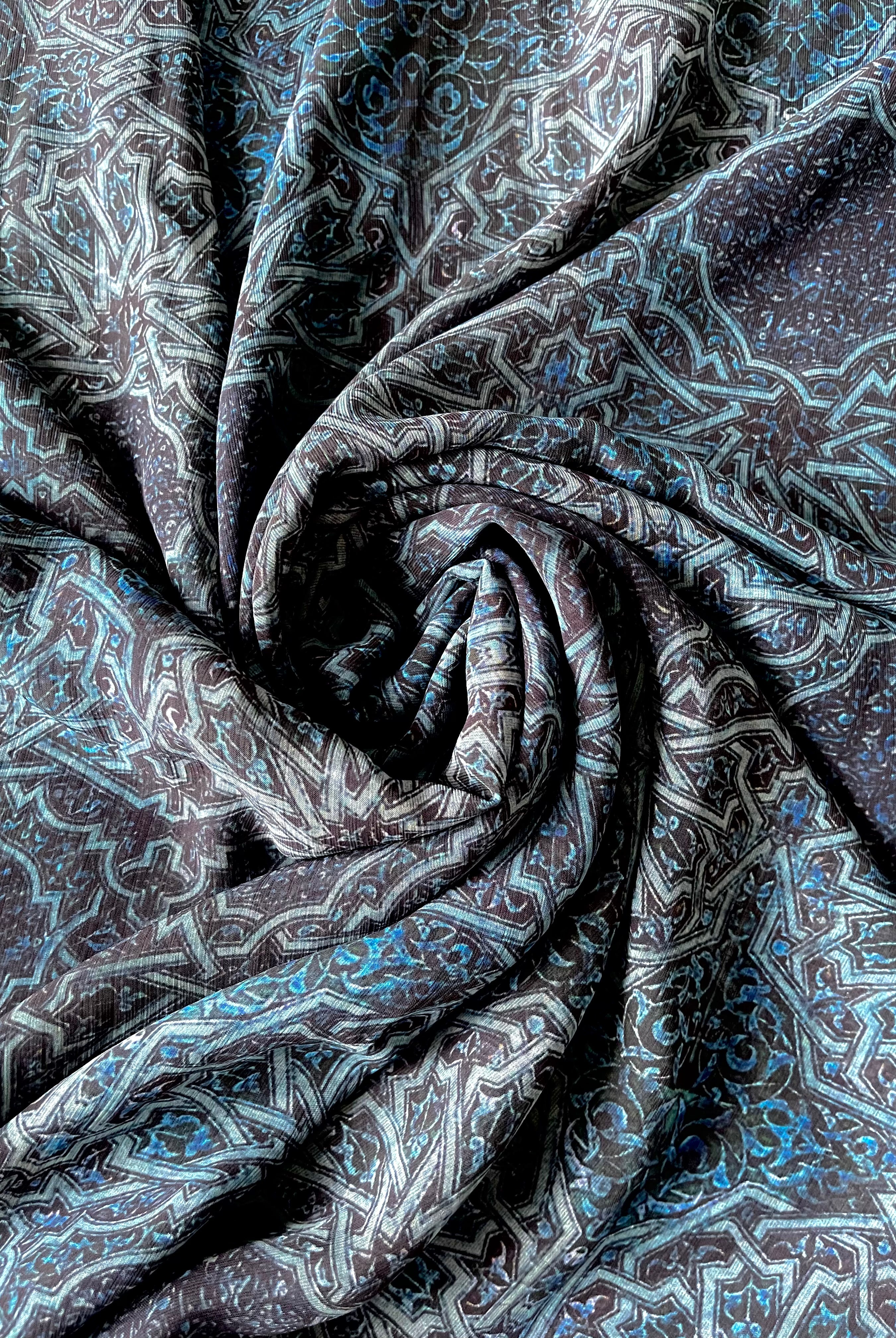 A royal blue chiffon hijab with intricate print details.