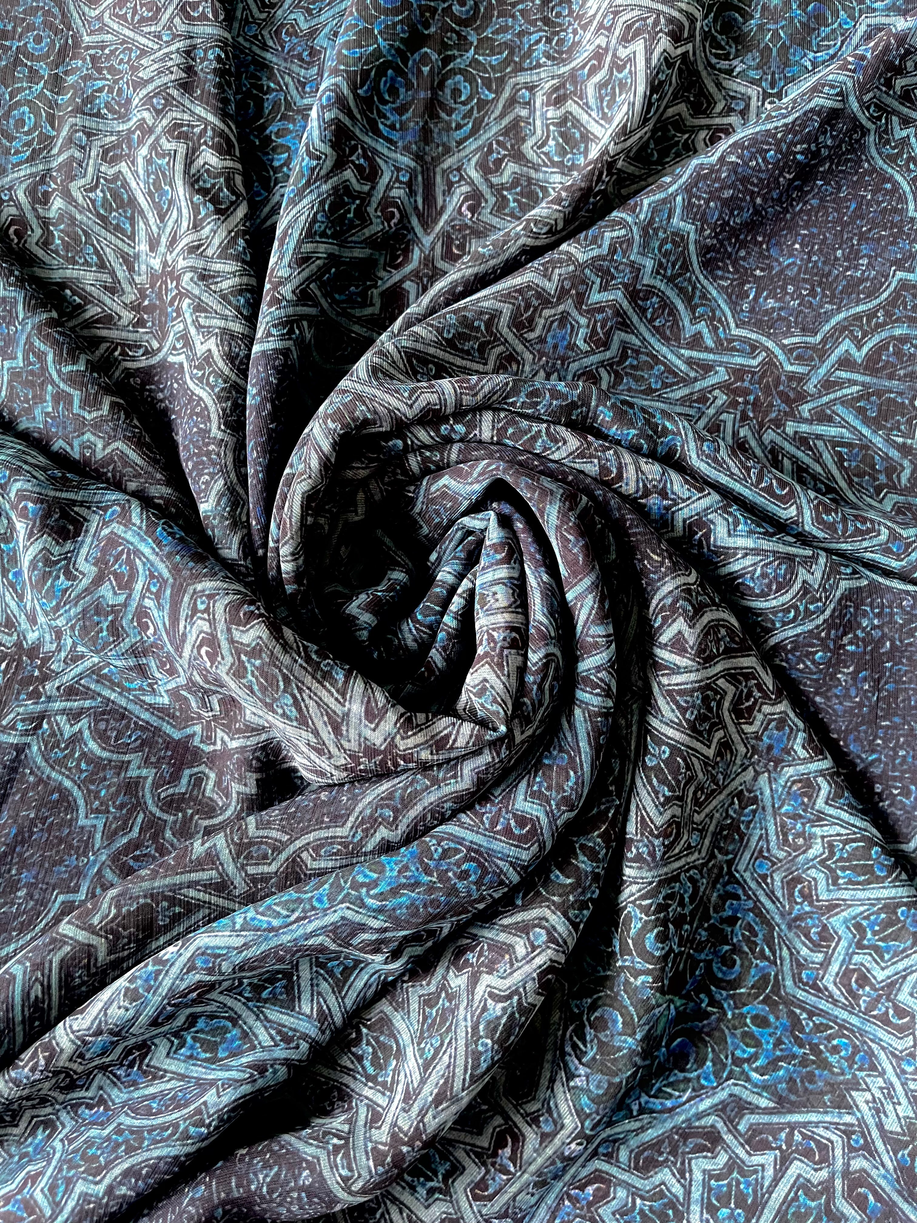 A royal blue chiffon hijab with intricate print details.