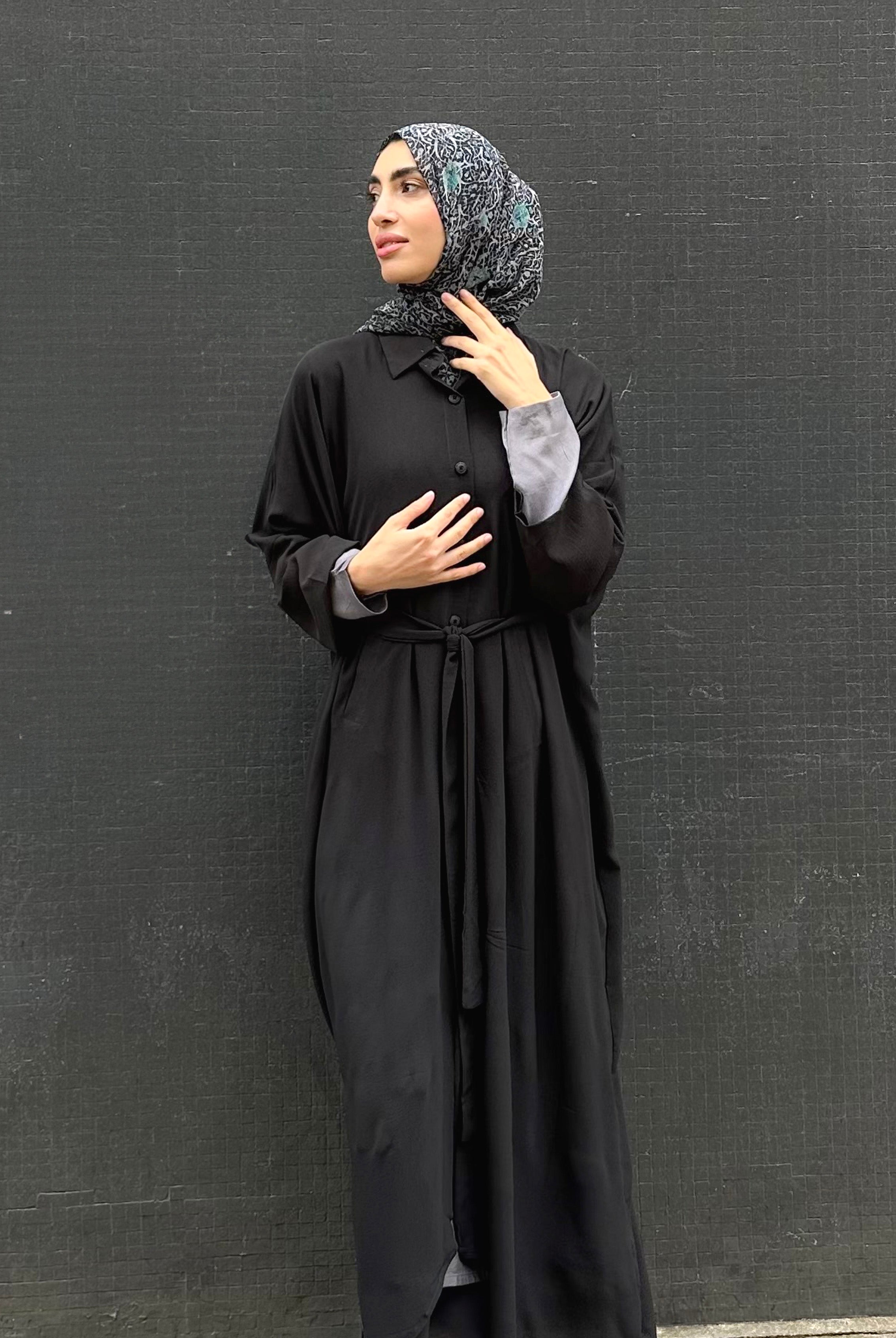 Woman in a long black Kaftan and headscarf or hijab