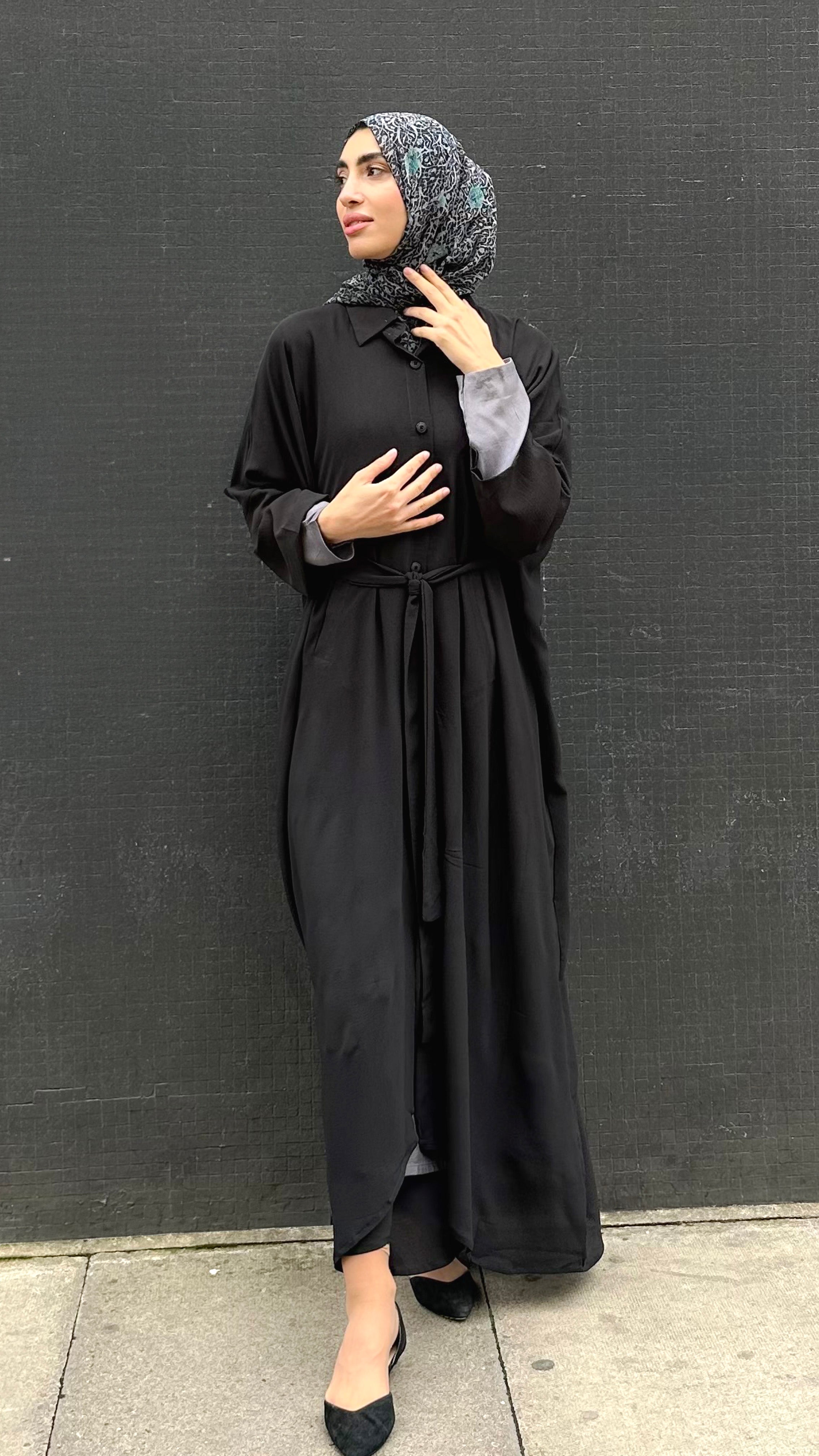 Woman in a long black Kaftan and headscarf or hijab