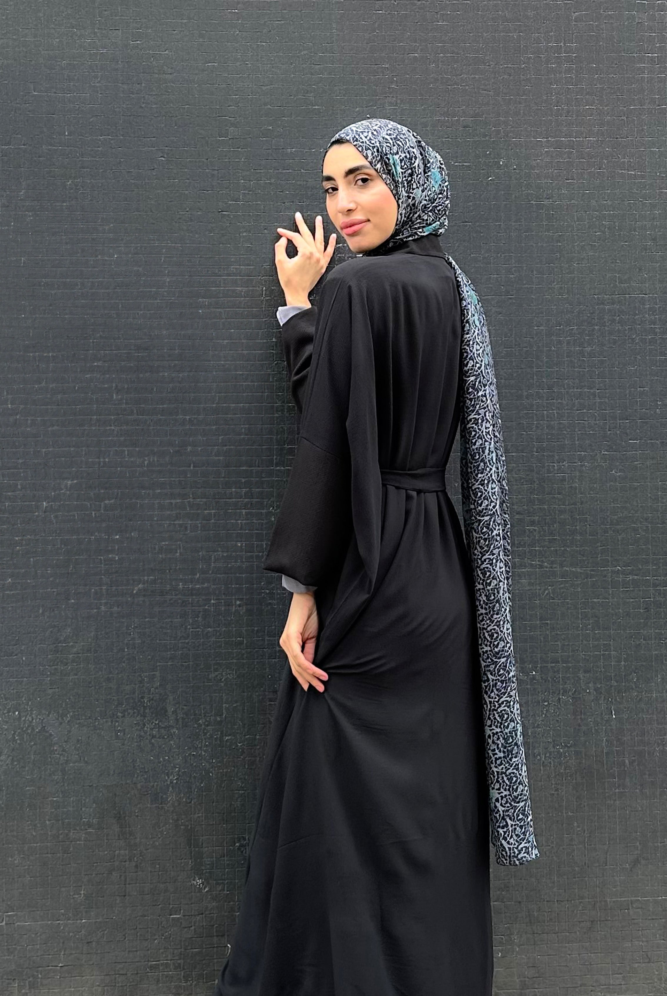 Woman in a long black Kaftan and headscarf  or hijab