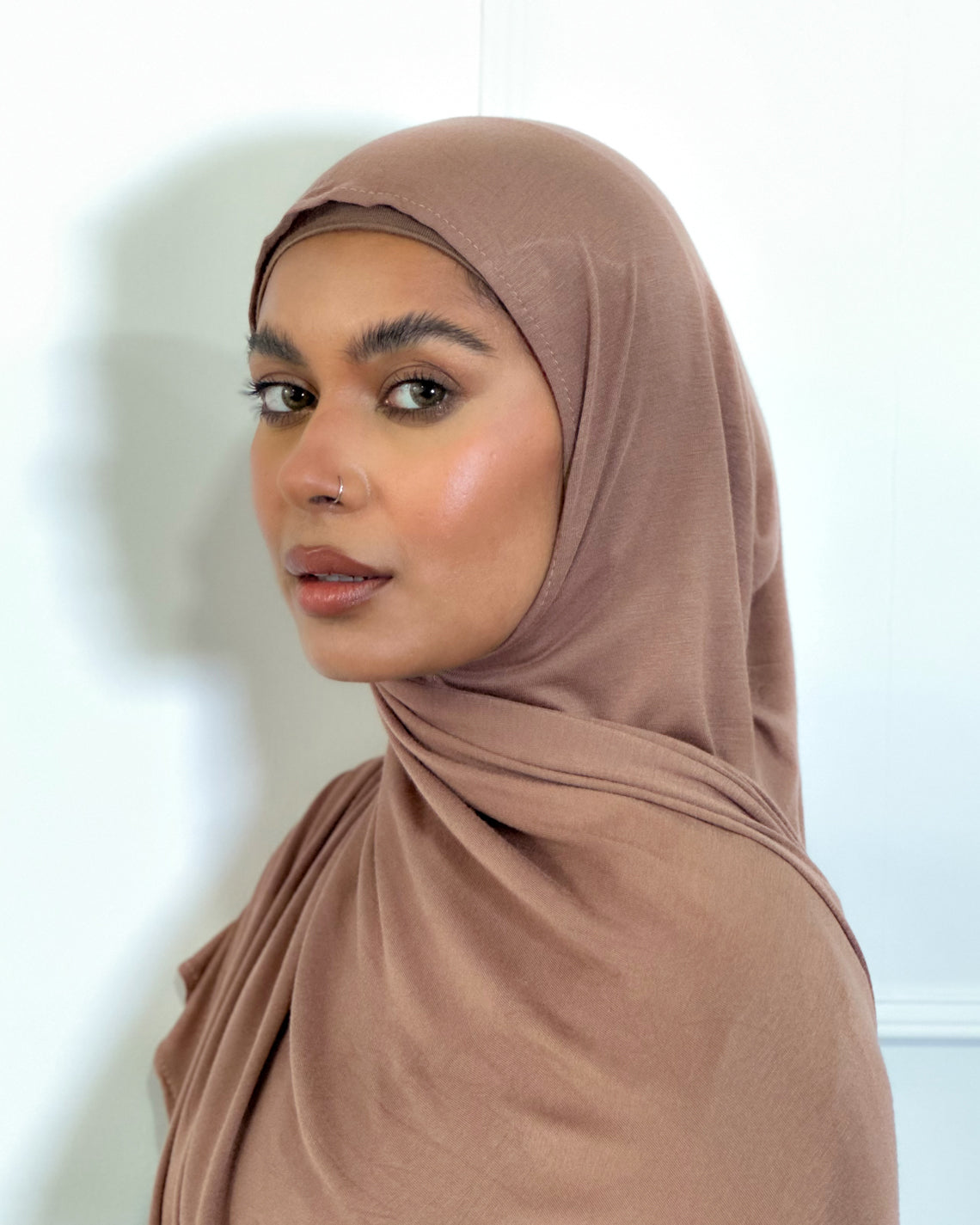 A woman wearing a brown modal maxi jersey hijab. modal jersey hijab