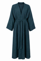 Model wearing the Fayrouz teal linen jacket over the matching Fayrouz abaya