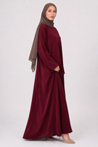 Full length maroon everyday abaya with loose flowing fit and wide sleeves