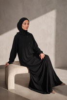 Full length view of the black hooded modest jacket