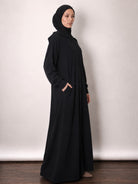 Hooded jersey jacket shown open over an everyday abaya