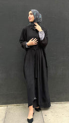 Woman in a long black Kaftan and headscarf  or hijab 
