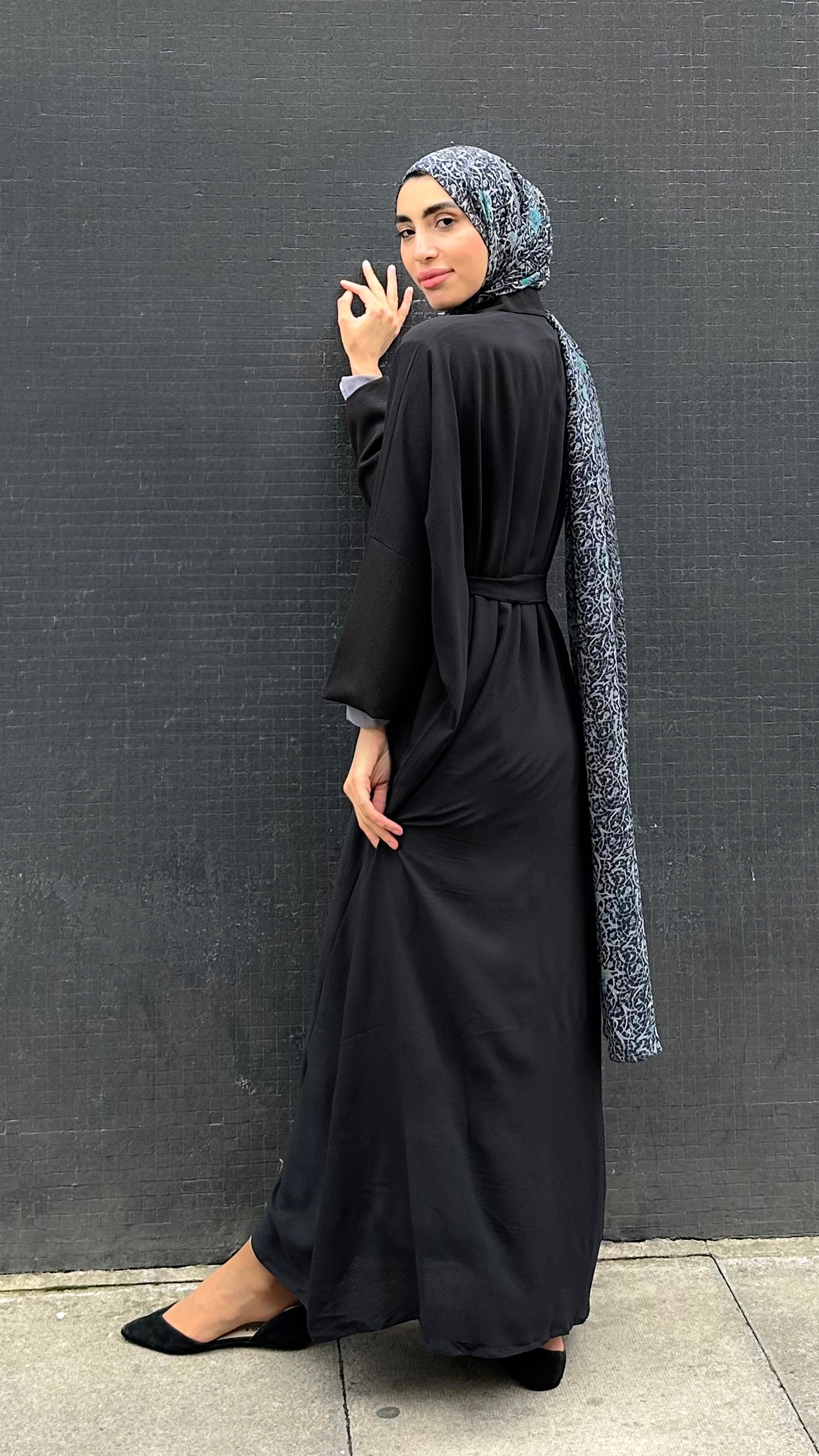 Woman in a long black Kaftan and headscarf  or hijab 