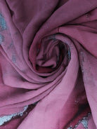 A pink chiffon scarf with a floral pattern and a twisted, swirling shape.