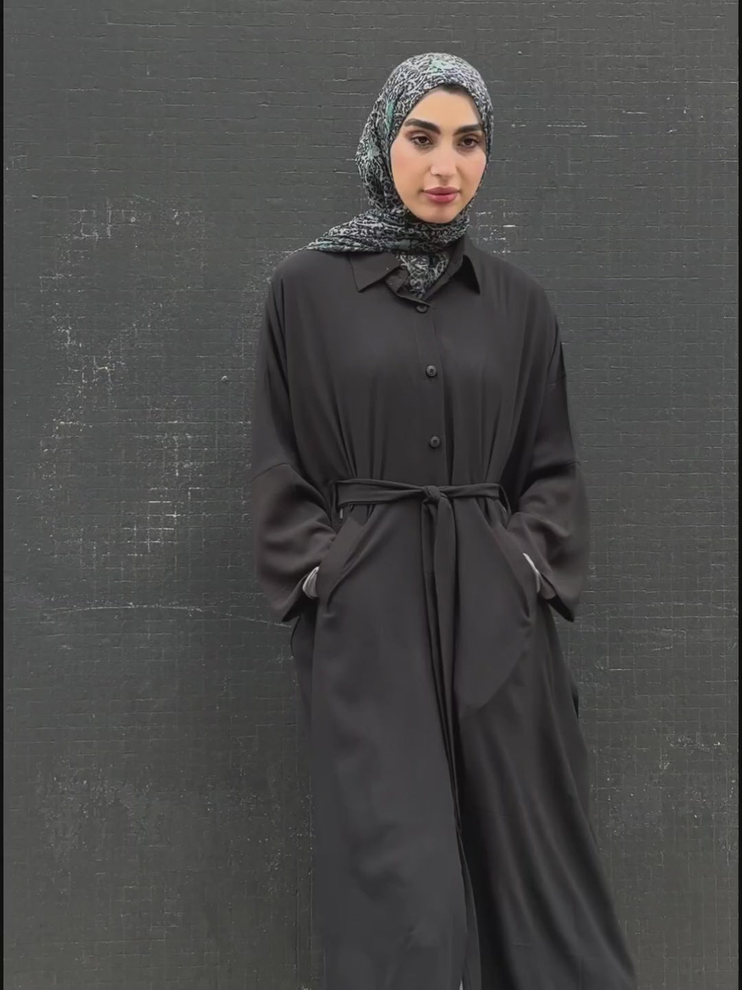 Woman in a long black Kaftan and headscarf  or hijab 