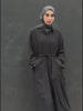 Woman in a long black Kaftan and headscarf  or hijab 